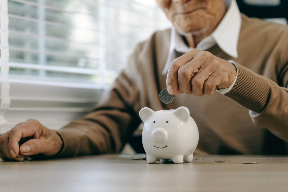 Saving,Money,Investment,For,Future.,Old,Man,Hand,Putting,Money